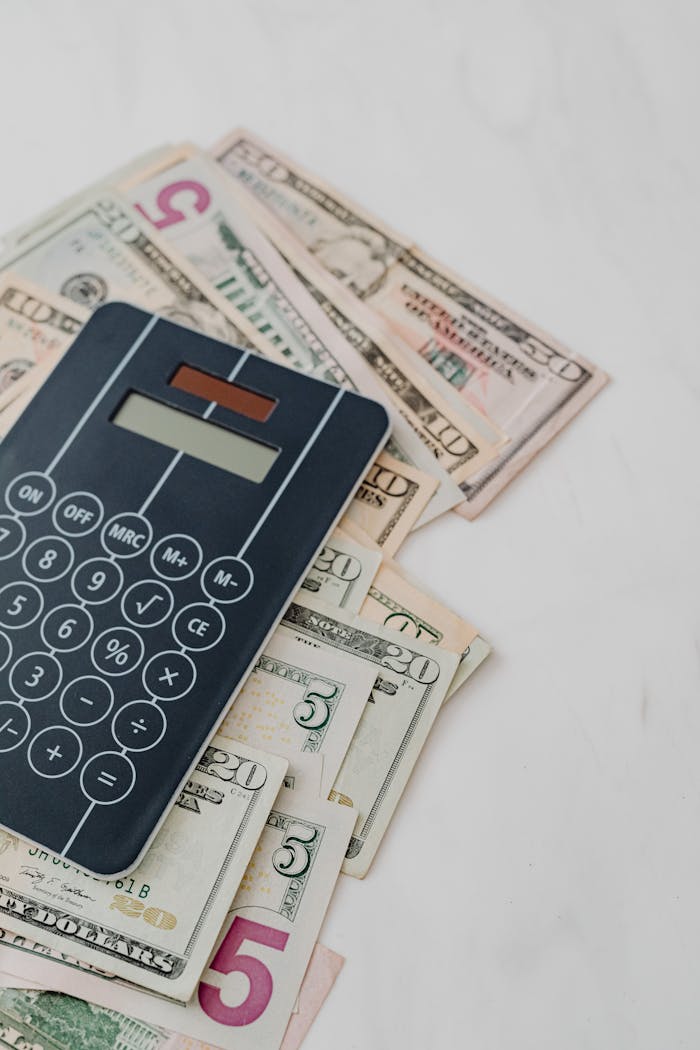 services-02 Calculator and US dollar banknotes, symbolizing finance and budgeting.