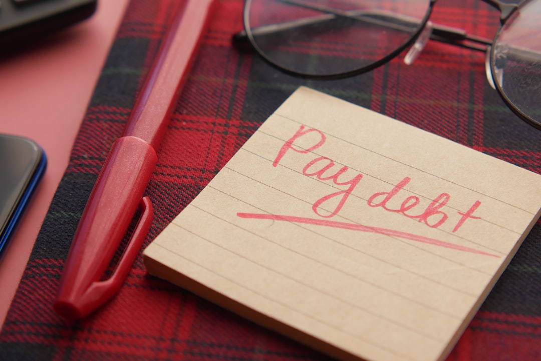 services-03 a-note-that-says-pay-debt-next-to-a-pen-and-glasses-m8z2swswpbg