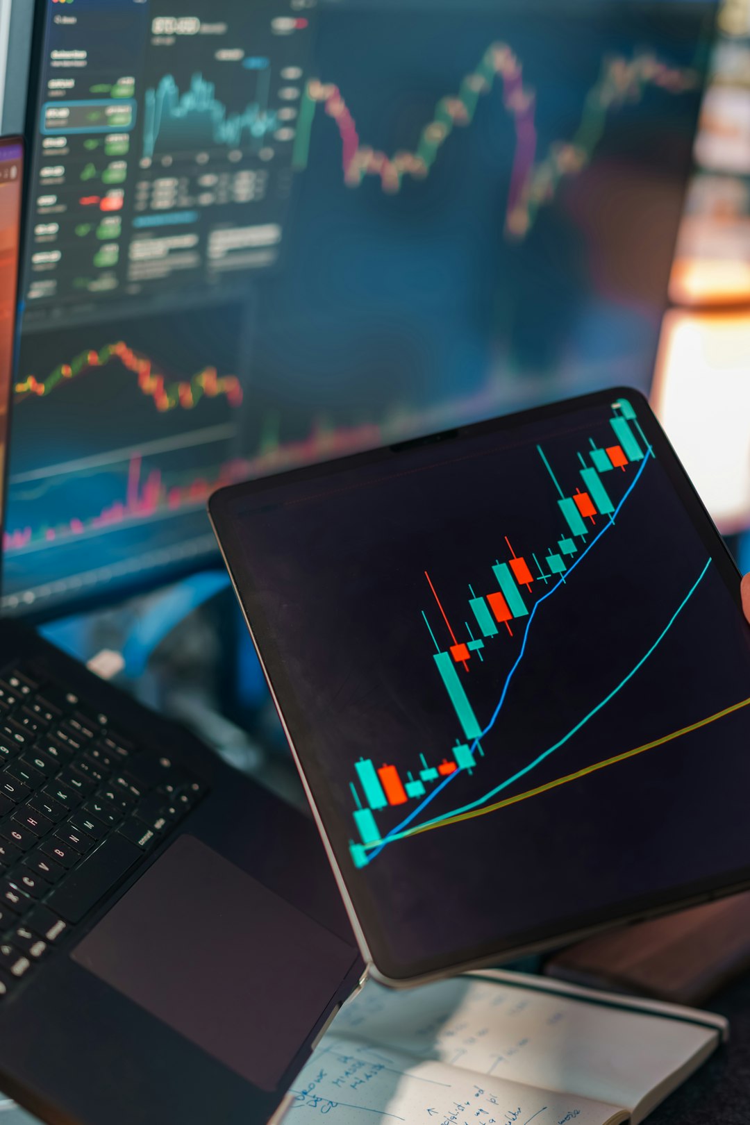services-04 Financial trading analytics candlestick chart laptop tablet. Digital market analysis workspace showing price movement graphs technical indicators data visualization screens investment finance concept editorial business technology